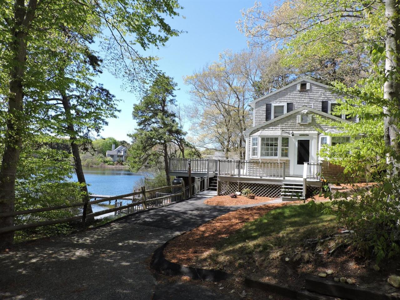 85 Huckins Neck Road Centerville, MA 02632 - Photo 3 of 23 a row of palm trees in front of a house