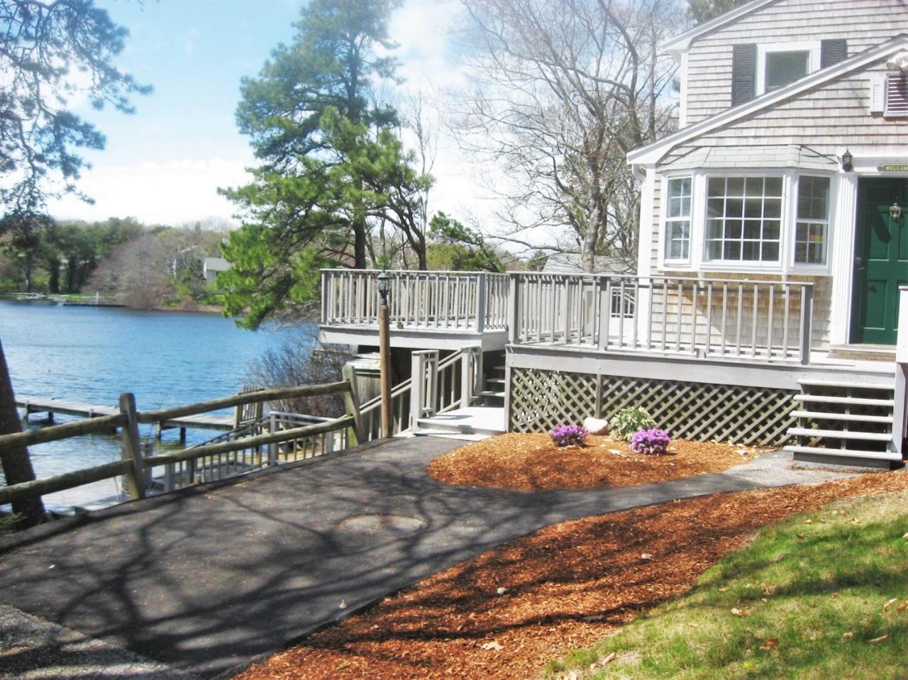 85 Huckins Neck Road Centerville, MA 02632 - Photo 8 of 23 a view of a deck with wooden floor and fence