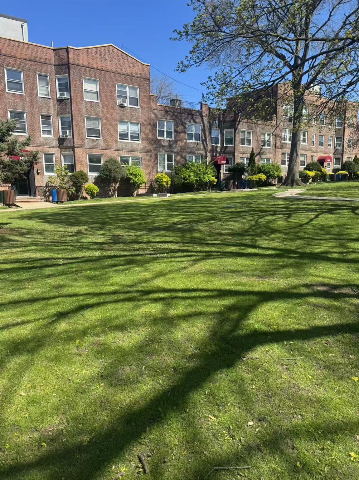 141-13 78th Road, Unit 2M Queens, NY 11367 - Photo 1 of 22 a front view of a building with a garden