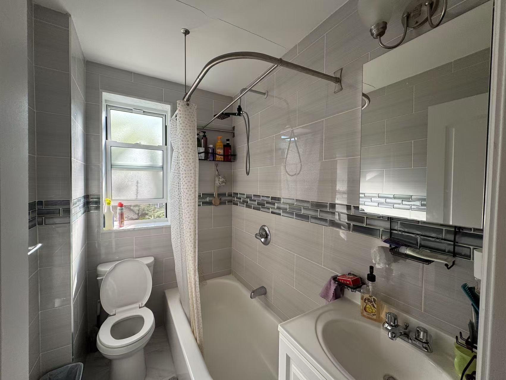 141-13 78th Road, Unit 2M Queens, NY 11367 - Photo 11 of 22 a bathroom with a sink toilet and shower