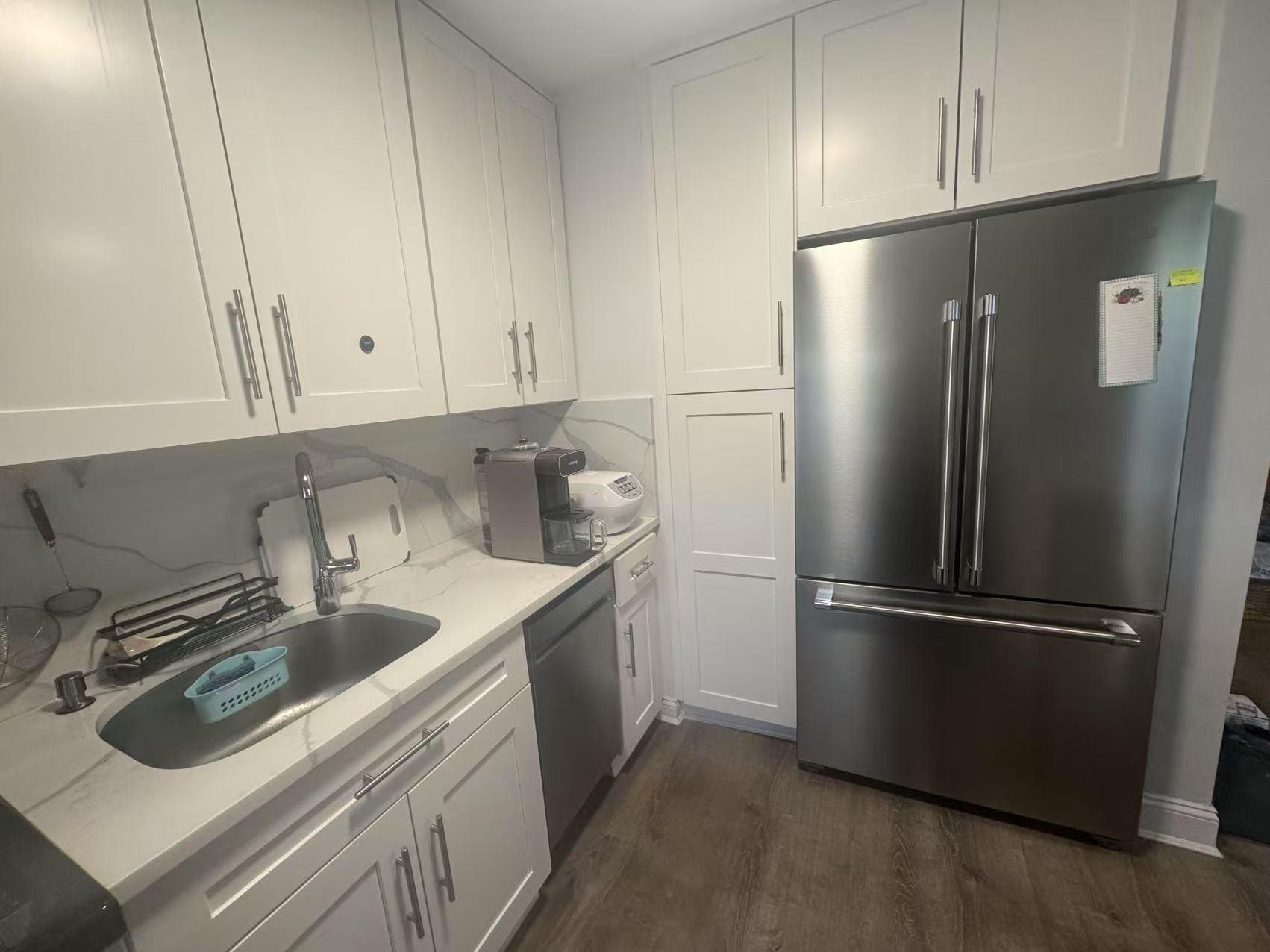 141-13 78th Road, Unit 2M Queens, NY 11367 - Photo 13 of 22 a kitchen with stainless steel appliances granite countertop a refrigerator and a sink