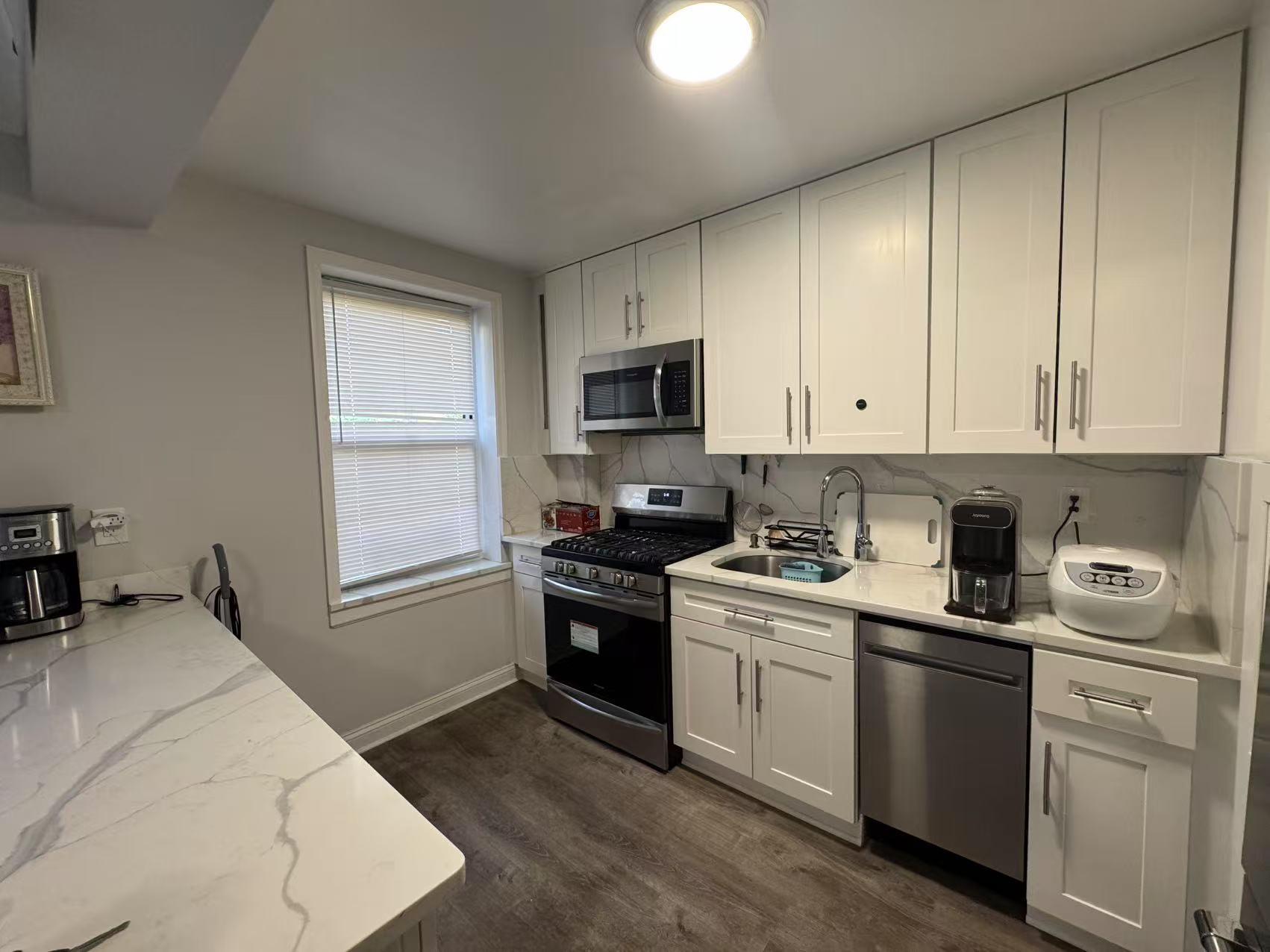 141-13 78th Road, Unit 2M Queens, NY 11367 - Photo 14 of 22 a kitchen with a sink stove and refrigerator