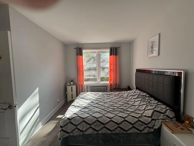 a bedroom with a bed and window