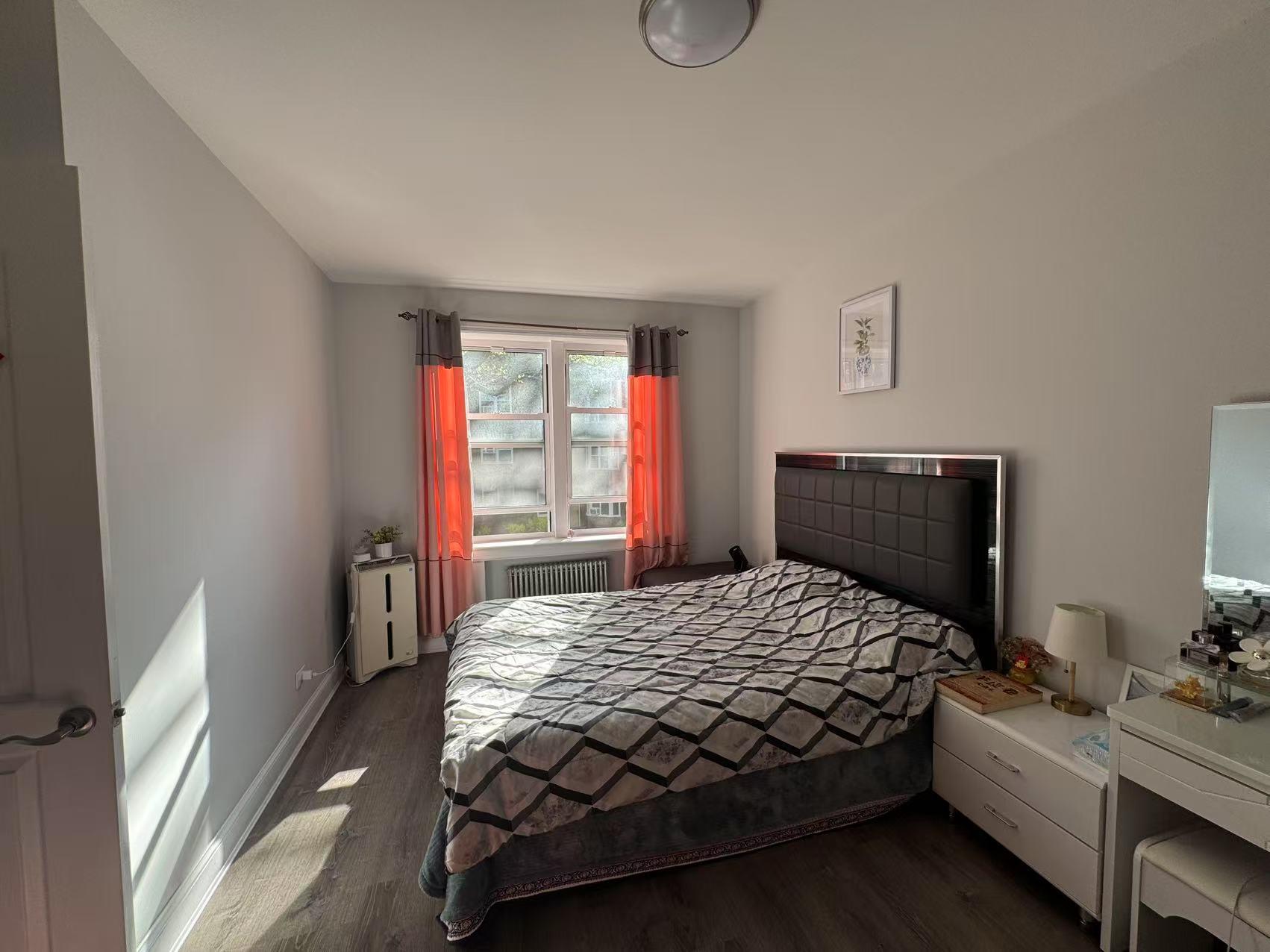 141-13 78th Road, Unit 2M Queens, NY 11367 - Photo 2 of 22 a bedroom with a bed and window