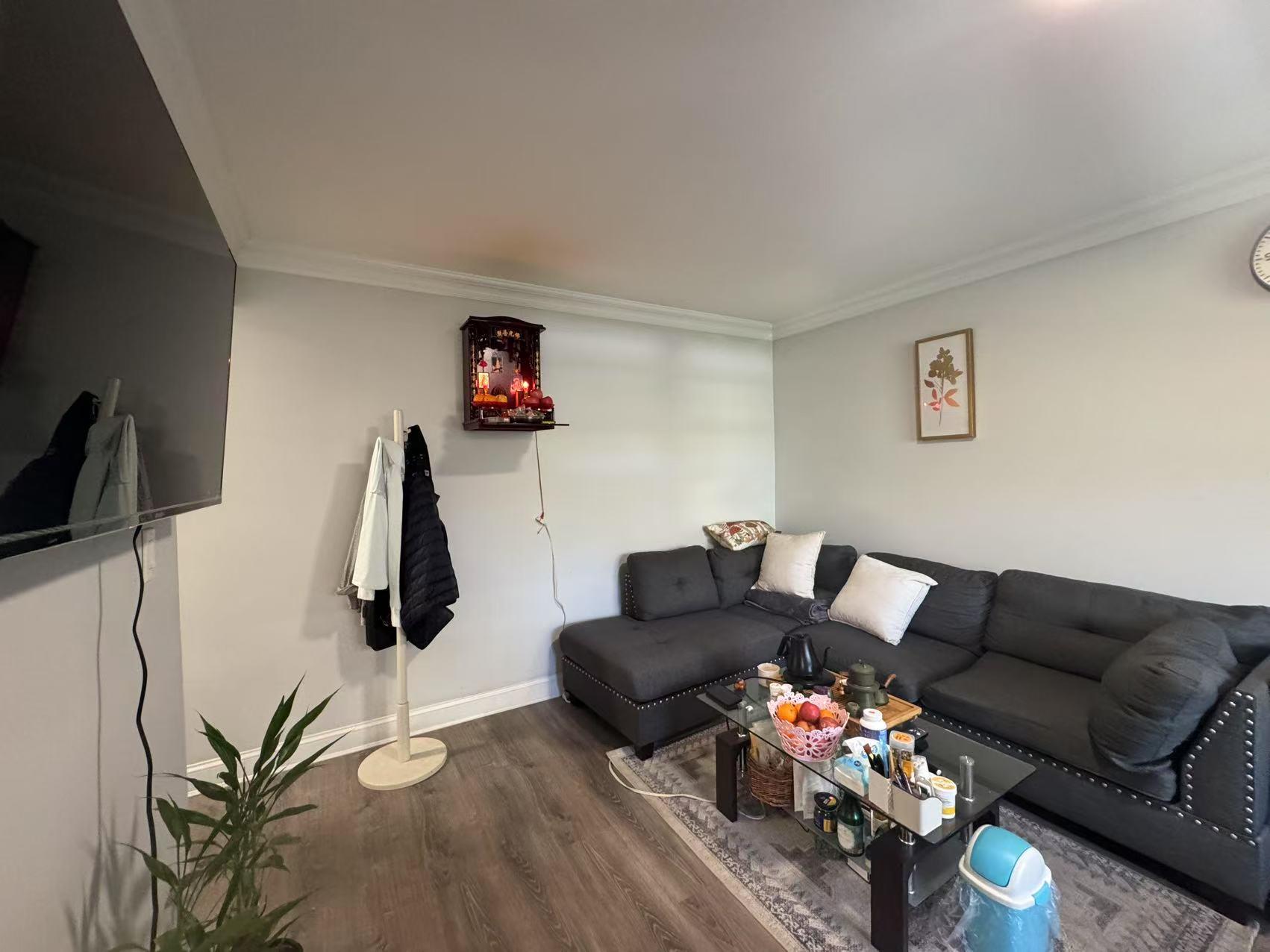 141-13 78th Road, Unit 2M Queens, NY 11367 - Photo 7 of 22 a living room with furniture and a flat screen tv