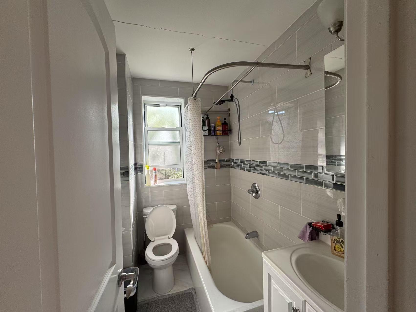 141-13 78th Road, Unit 2M Queens, NY 11367 - Photo 10 of 22 a bathroom with a granite countertop sink a toilet and shower
