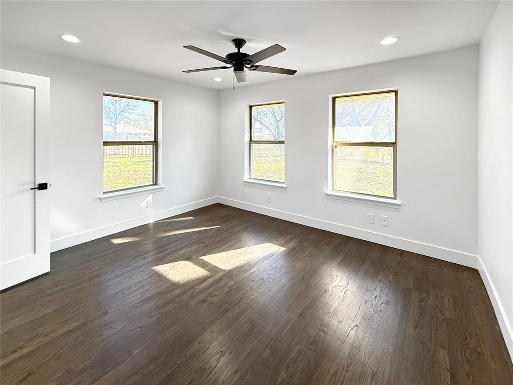 425 Chesier Road Lancaster, TX 75146 - Photo 13 of 15 a view of an empty room with wooden floor and a window