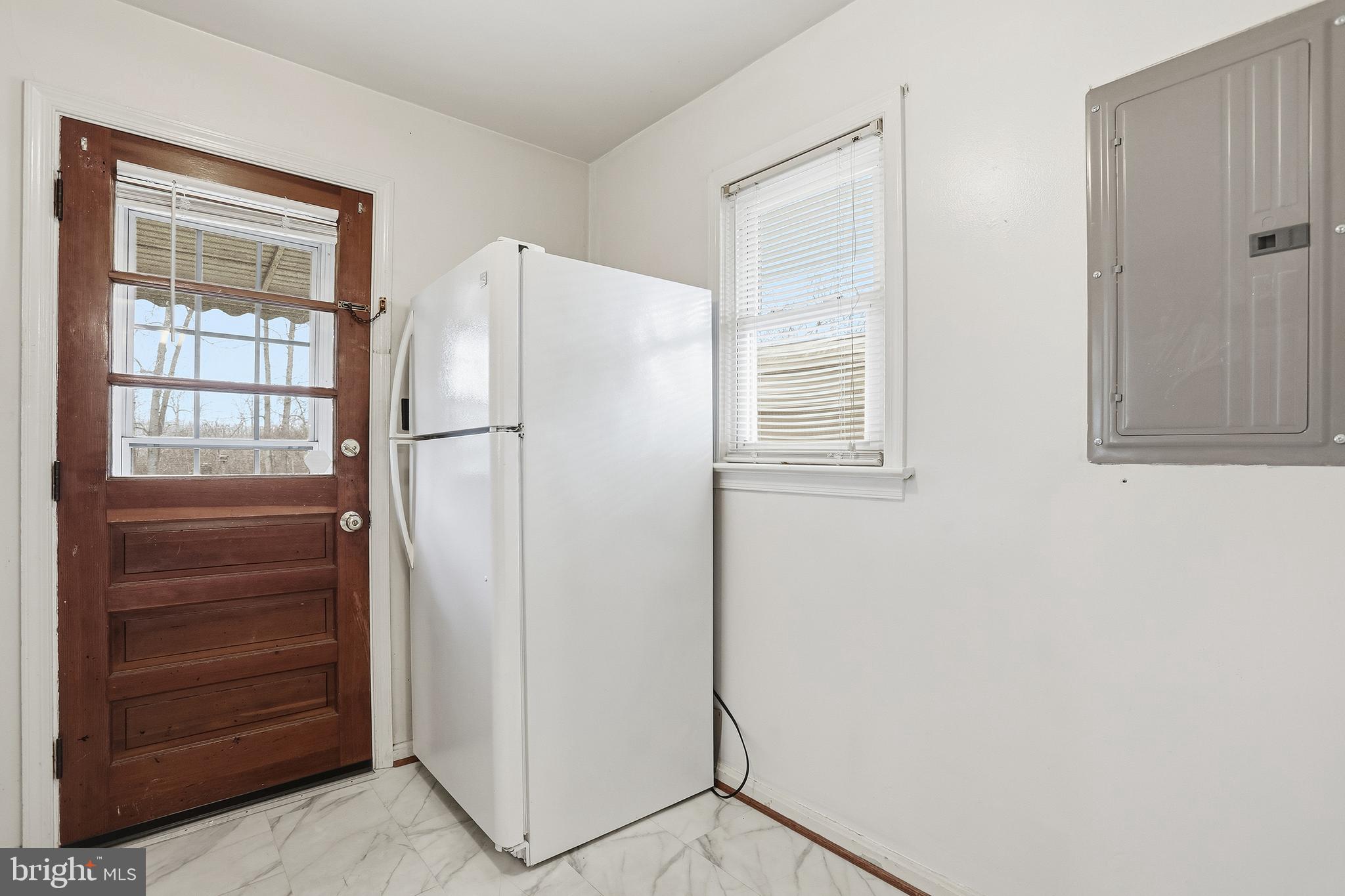 204 Musselman Road Fredericksburg, VA 22405 - Photo 13 of 32 a white refrigerator freezer and a cabinet in a room