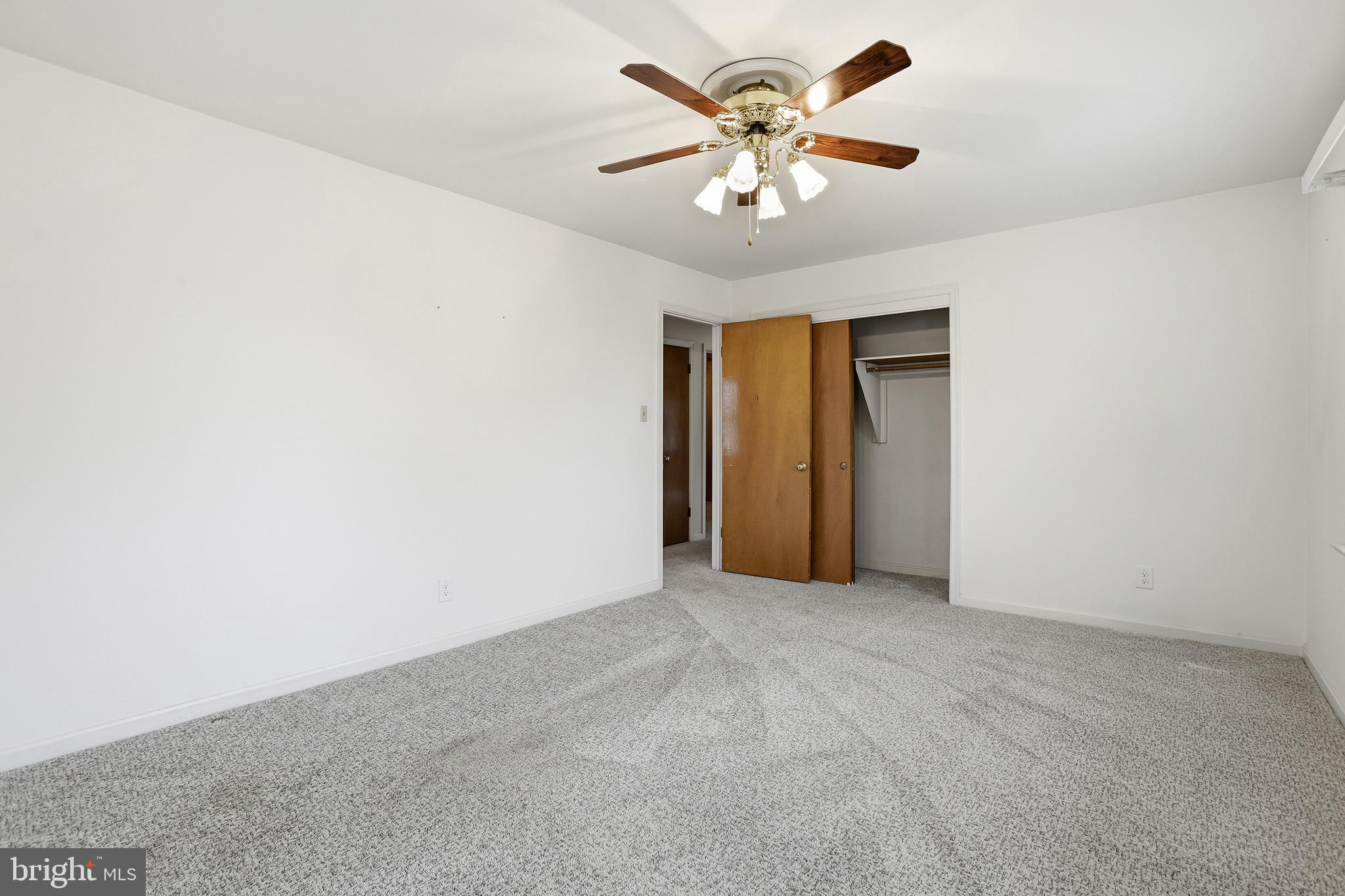 204 Musselman Road Fredericksburg, VA 22405 - Photo 15 of 32 an empty room with a chandelier fan and windows