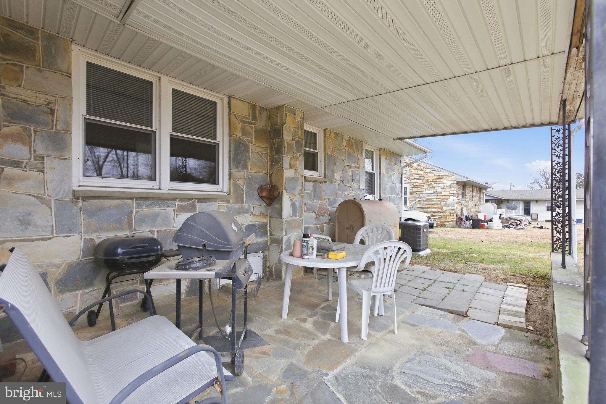 204 Musselman Road Fredericksburg, VA 22405 - Photo 23 of 32 a patio with table and chairs and potted plants