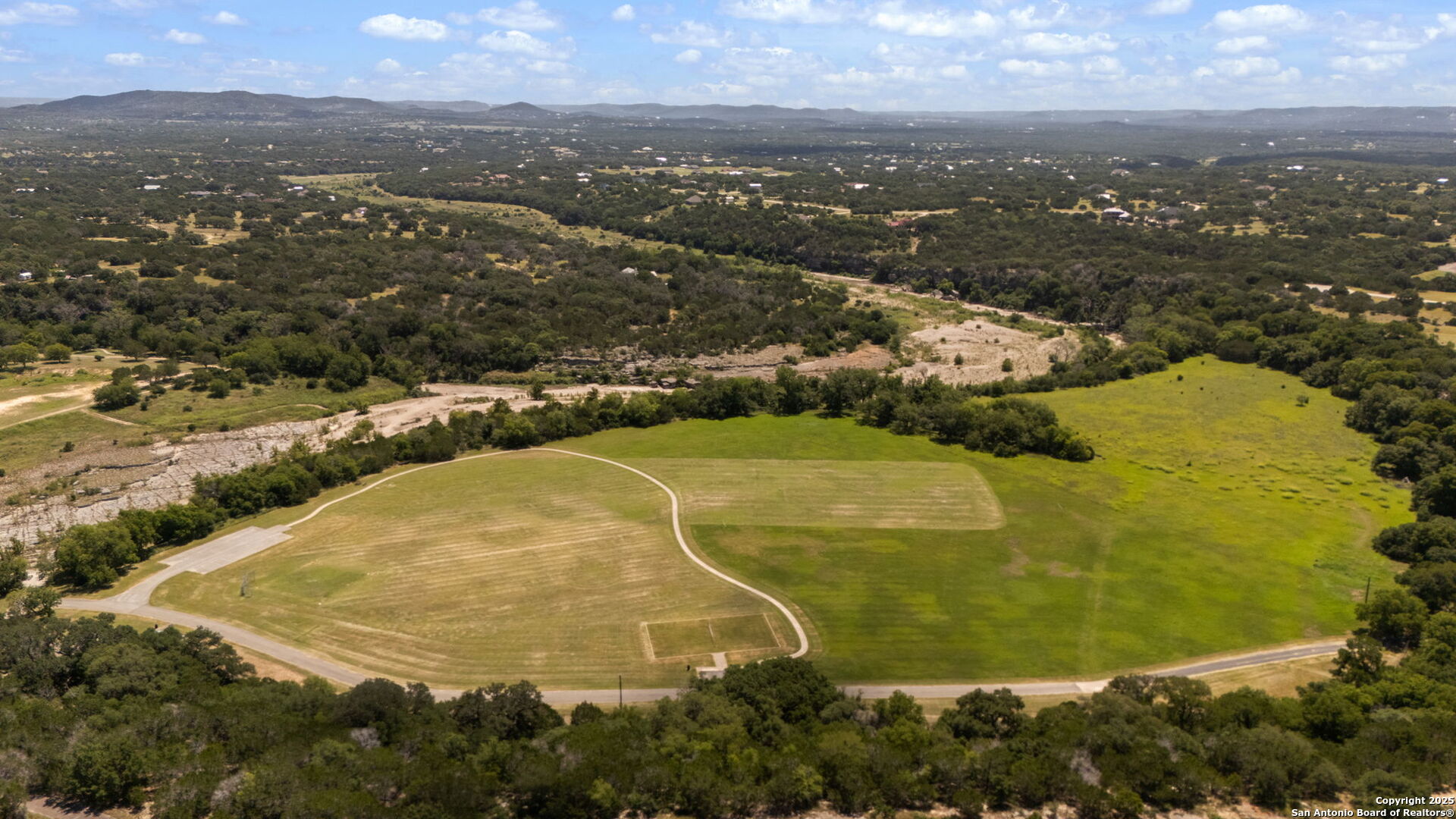1005 Buckskin Trail Bandera, TX 78003 - Photo 23 of 27 an aerial view of residential houses with outdoor space