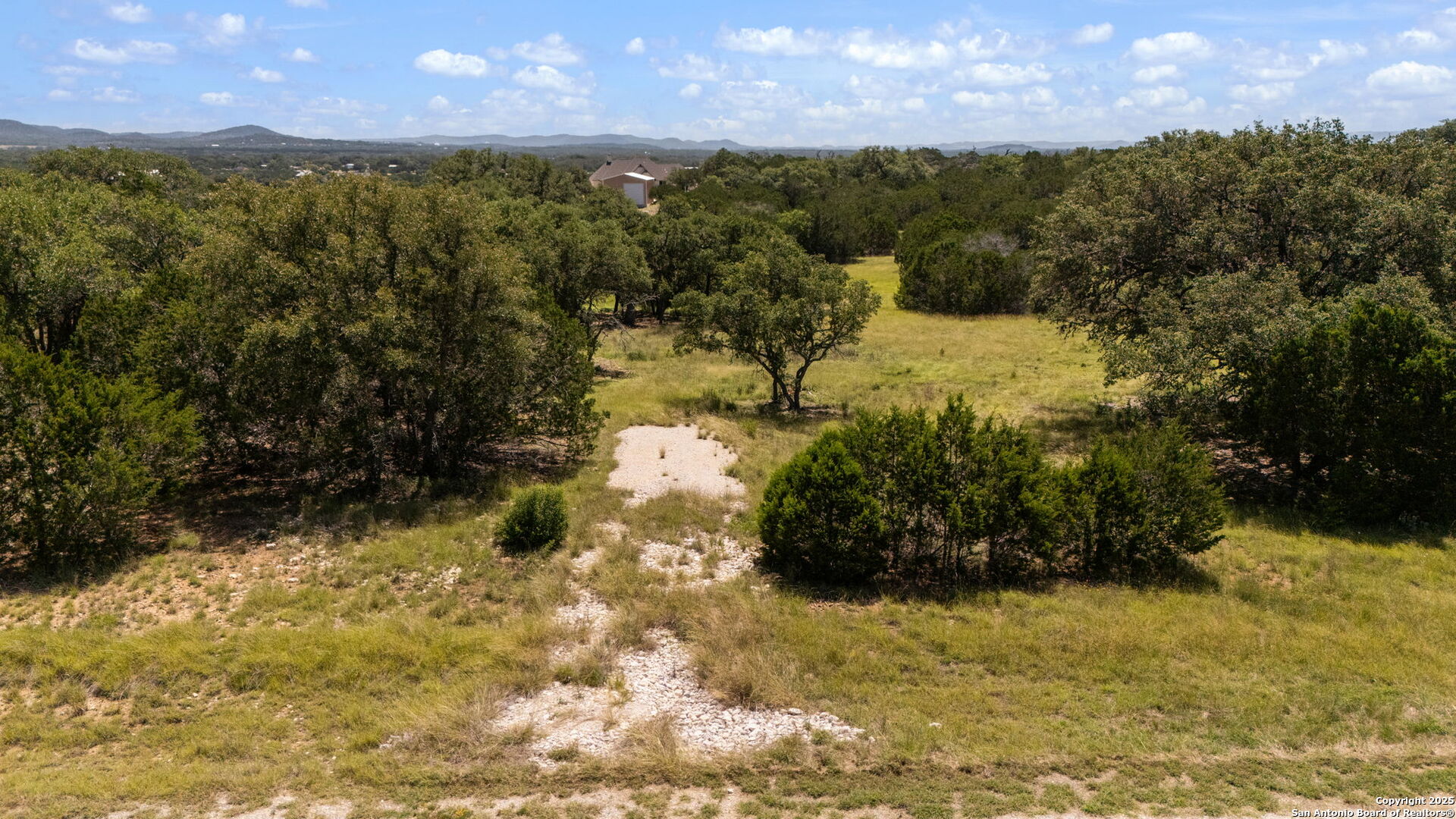 1005 Buckskin Trail Bandera, TX 78003 - Photo 7 of 27 a view of a yard with wooden fence