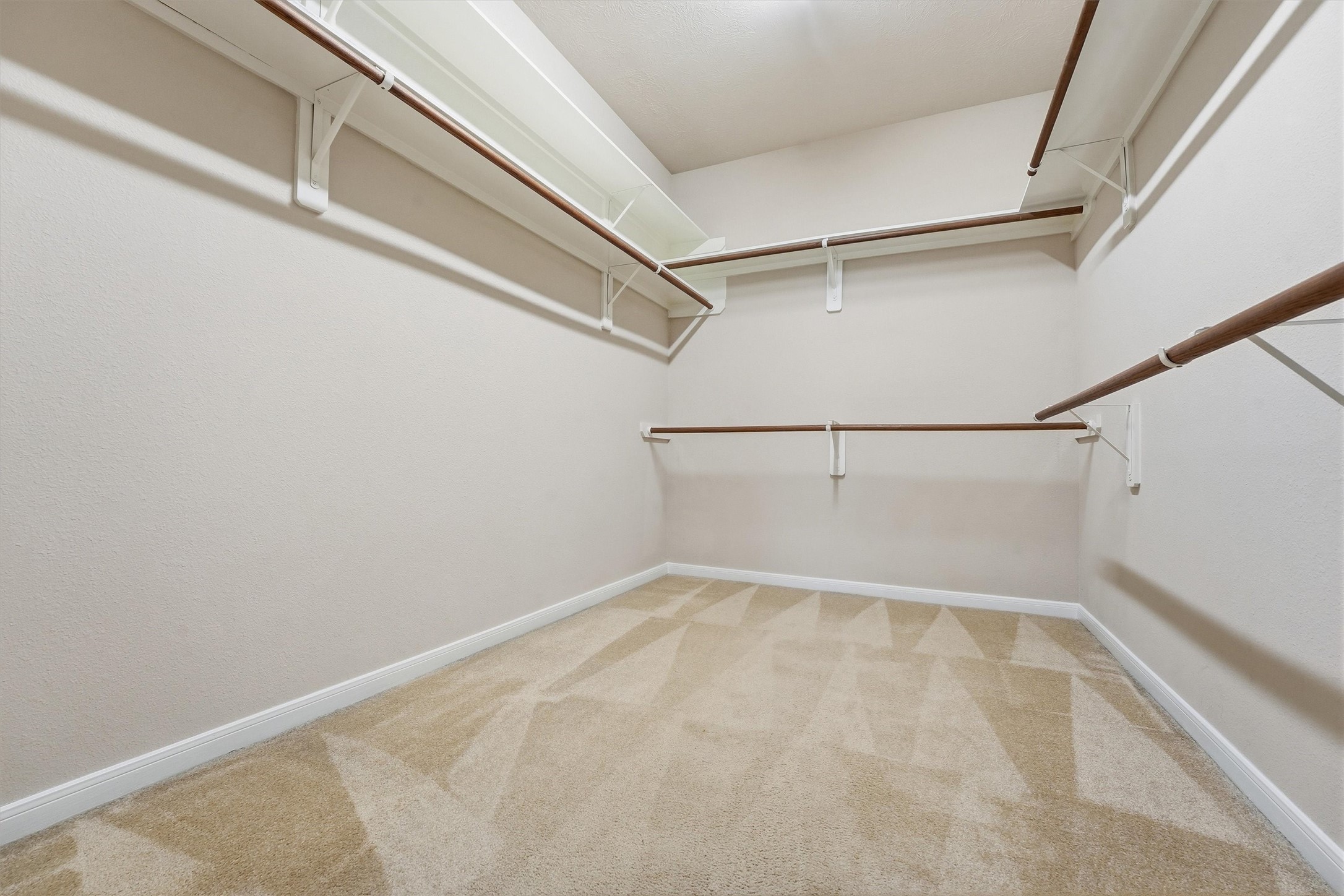 17415 Memorial Mills Drive Spring, TX 77379 - Photo 18 of 37 Oversized primary walk-in closet with built-in shelving and plenty of hanging space.