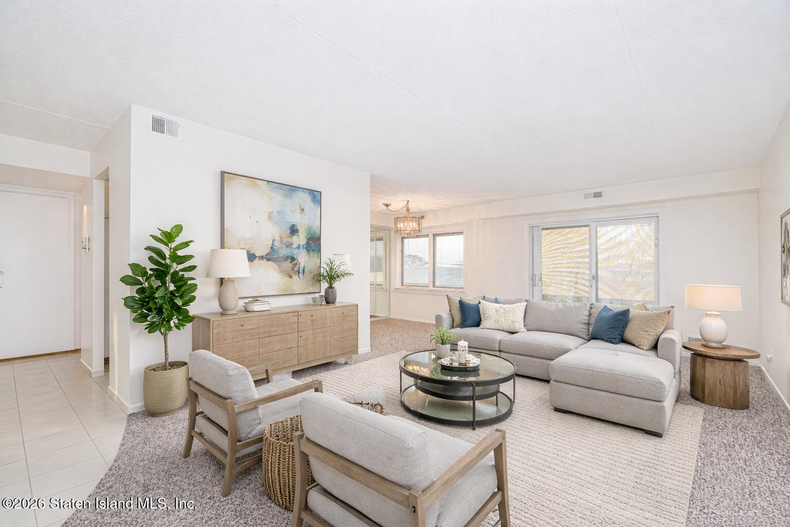 5 Windham Loop, Unit 4M Staten Island, NY 10314 - Photo 10 of 36 a living room with furniture and a potted plant