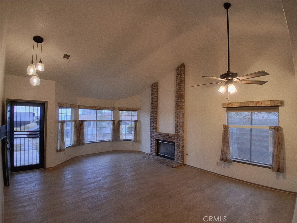 566 East Ave R8 Palmdale, CA 93550 - Photo 11 of 25 a view of an empty room with window and wooden floor