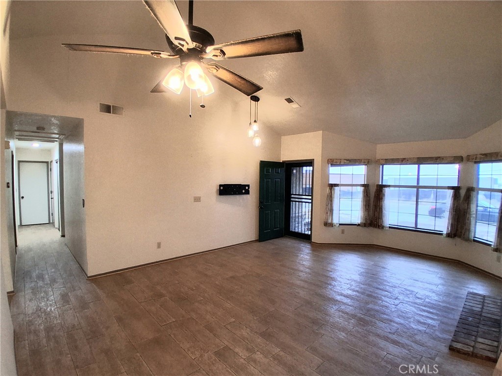 566 East Ave R8 Palmdale, CA 93550 - Photo 12 of 25 a view of an empty room with window and wooden floor