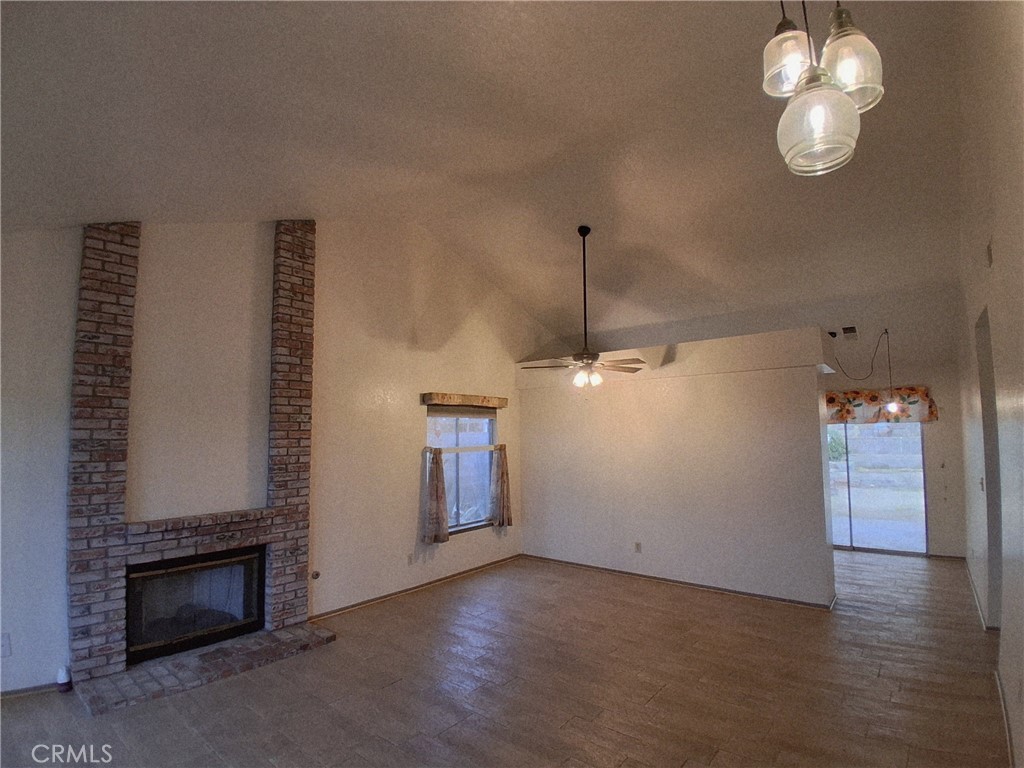 566 East Ave R8 Palmdale, CA 93550 - Photo 13 of 25 a view of a livingroom with a fireplace