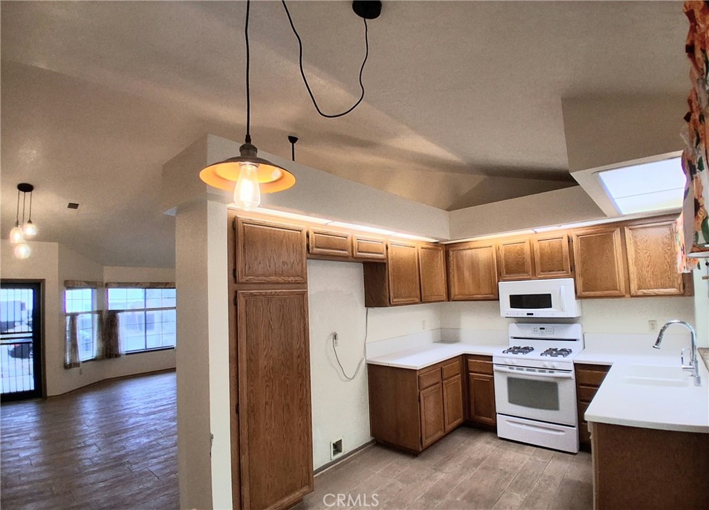 566 East Ave R8 Palmdale, CA 93550 - Photo 14 of 25 a kitchen with stainless steel appliances granite countertop a stove a sink and a refrigerator