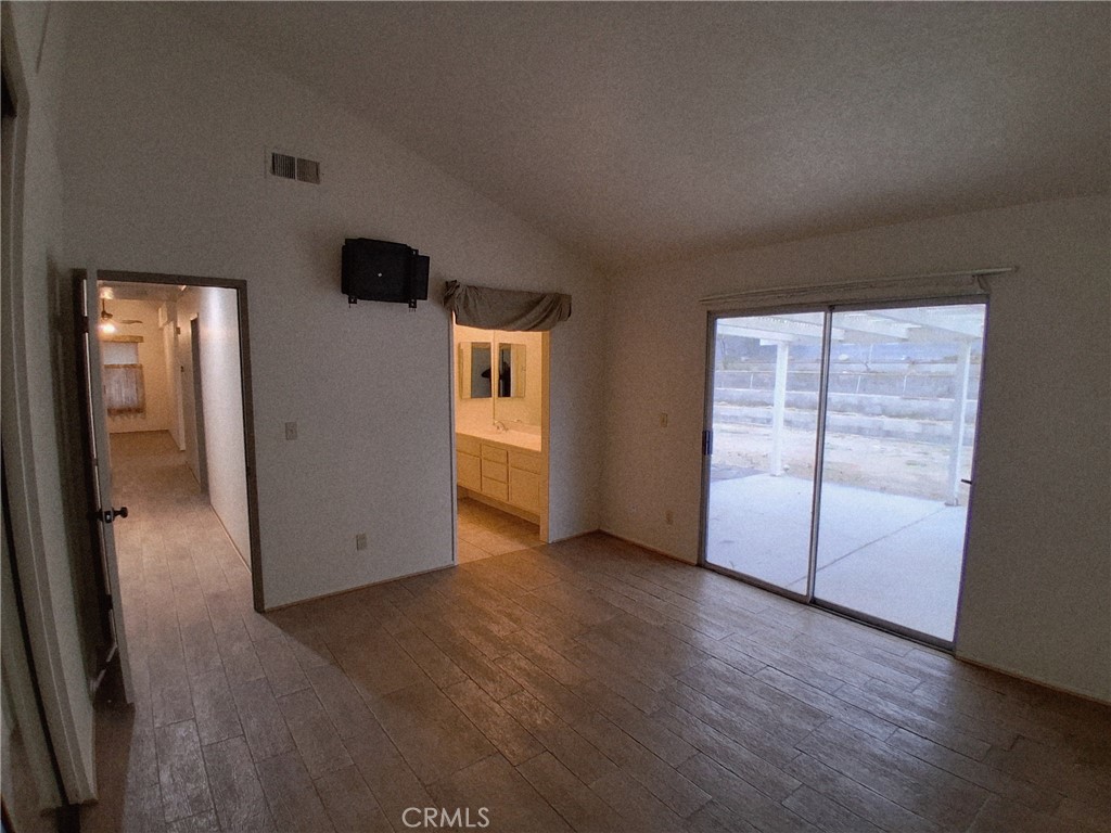566 East Ave R8 Palmdale, CA 93550 - Photo 16 of 25 an empty room with wooden floor and windows