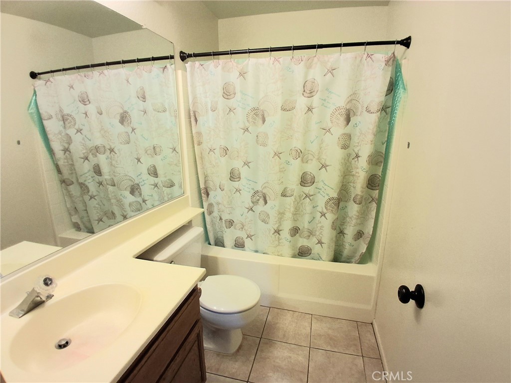 566 East Ave R8 Palmdale, CA 93550 - Photo 20 of 25 a bathroom with a sink and a mirror