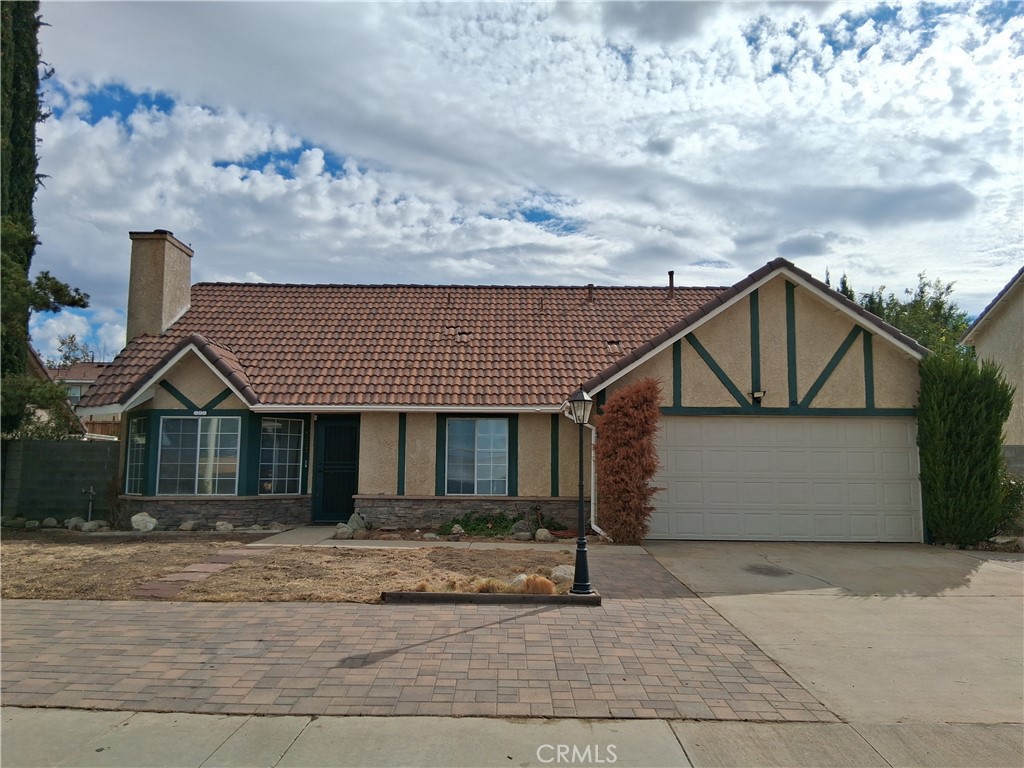 566 East Ave R8 Palmdale, CA 93550 - Photo 7 of 25 a front view of a house with a yard