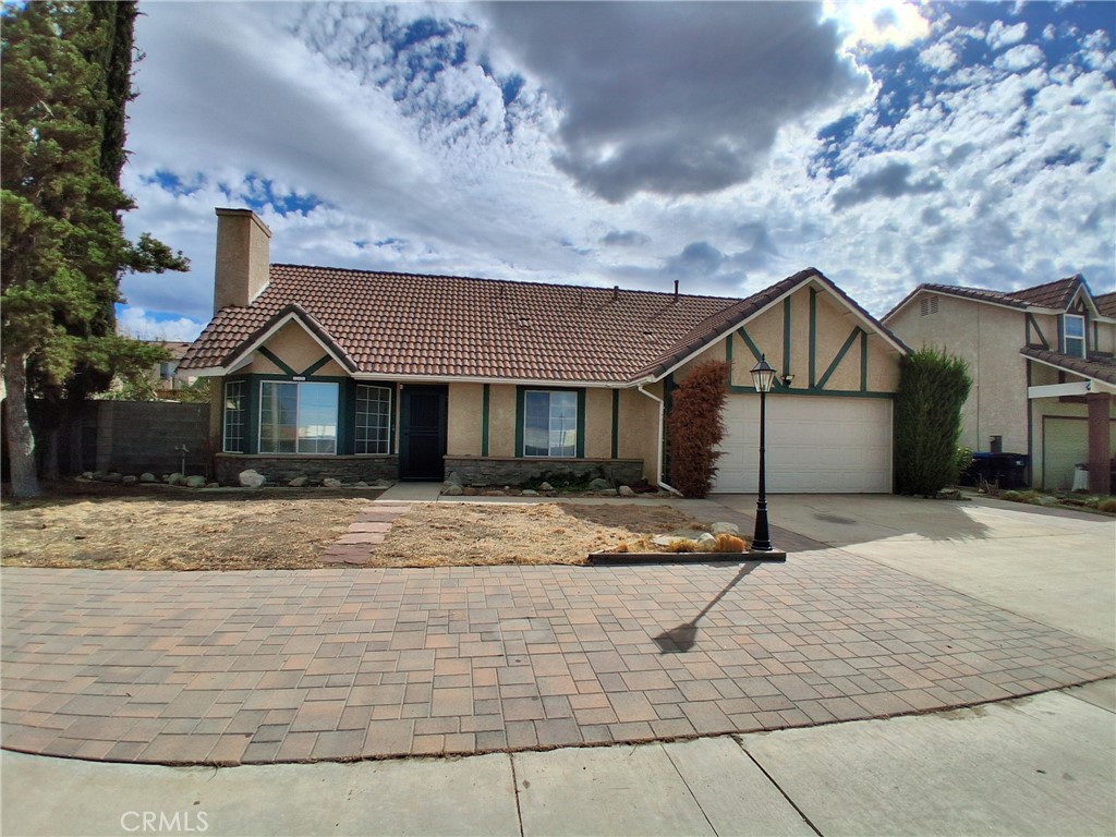 566 East Ave R8 Palmdale, CA 93550 - Photo 8 of 25 a front view of a house with a yard and garage
