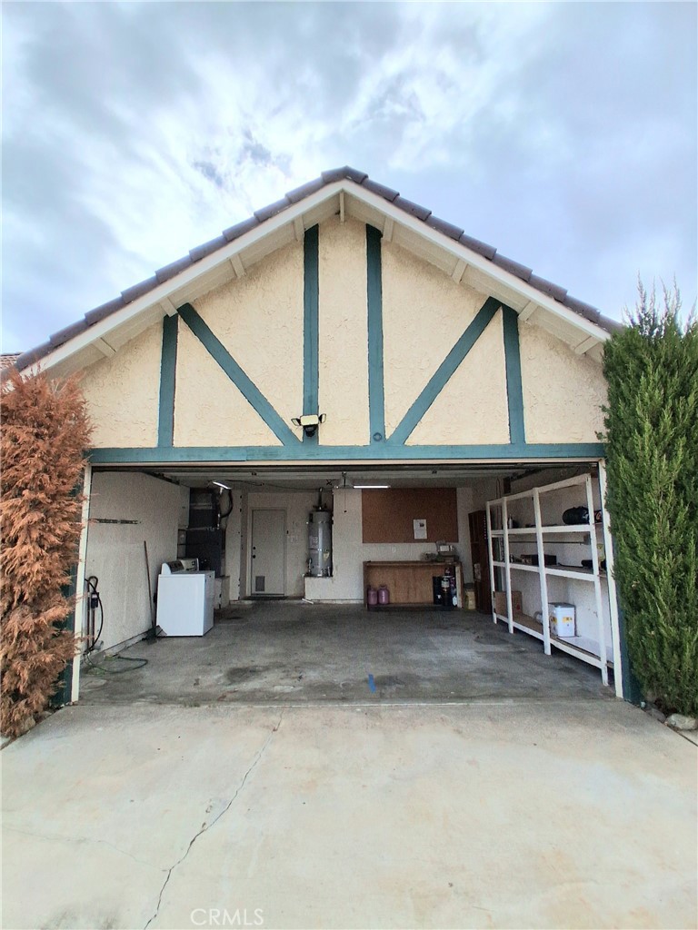 566 East Ave R8 Palmdale, CA 93550 - Photo 10 of 25 a front view of a house with garage