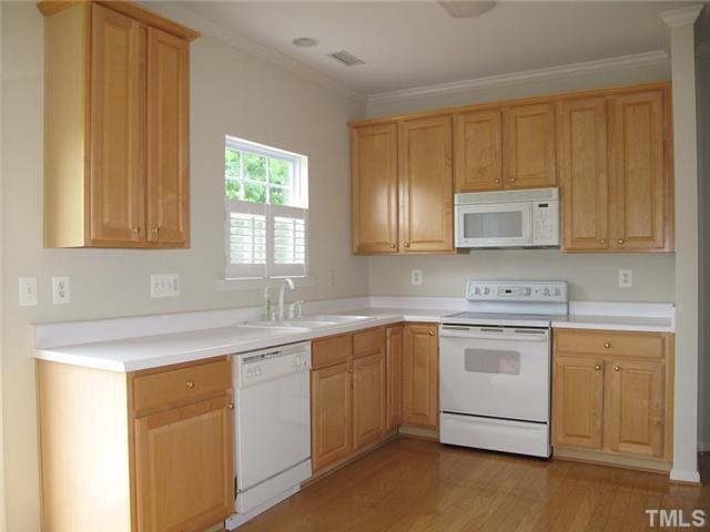 1100 Garnet Ridge Way Raleigh, NC 27607 - Photo 5 of 14 a kitchen with a sink stove and cabinets