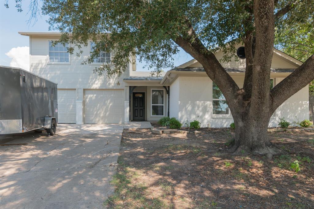 6004 Old Mill Court Watauga, TX 76148 - Photo 1 of 1 a front view of a house with a garden and trees
