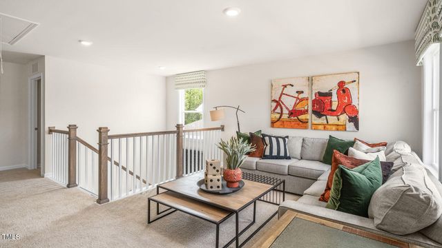 a living room with furniture and a wall painting