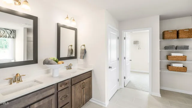 a bathroom with a double vanity sink mirror and shower