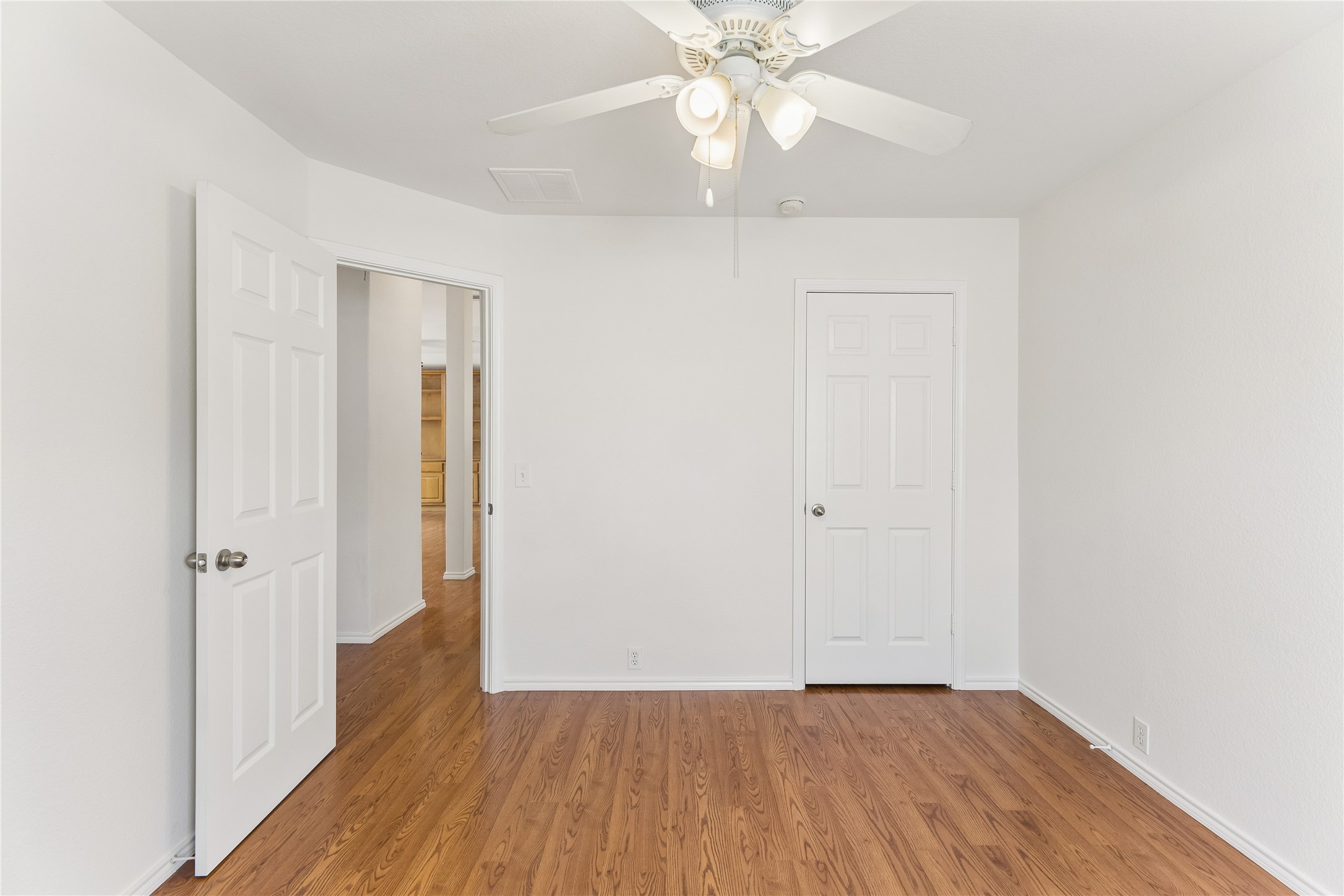 2372 Paradise Ridge Drive Round Rock, TX 78665 - Photo 32 of 40 Natural wood flooring complements this inviting space, featuring a classic ceiling fan for comfort.