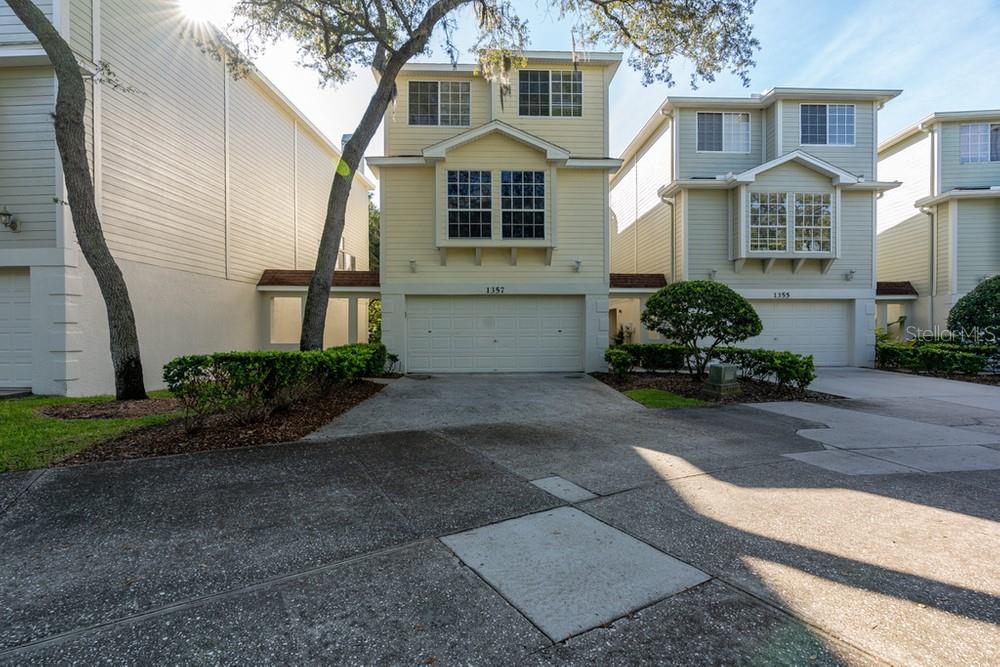 1357 Curlew Road Dunedin, FL 34698 - Photo 1 of 1 a front view of a house with a garden