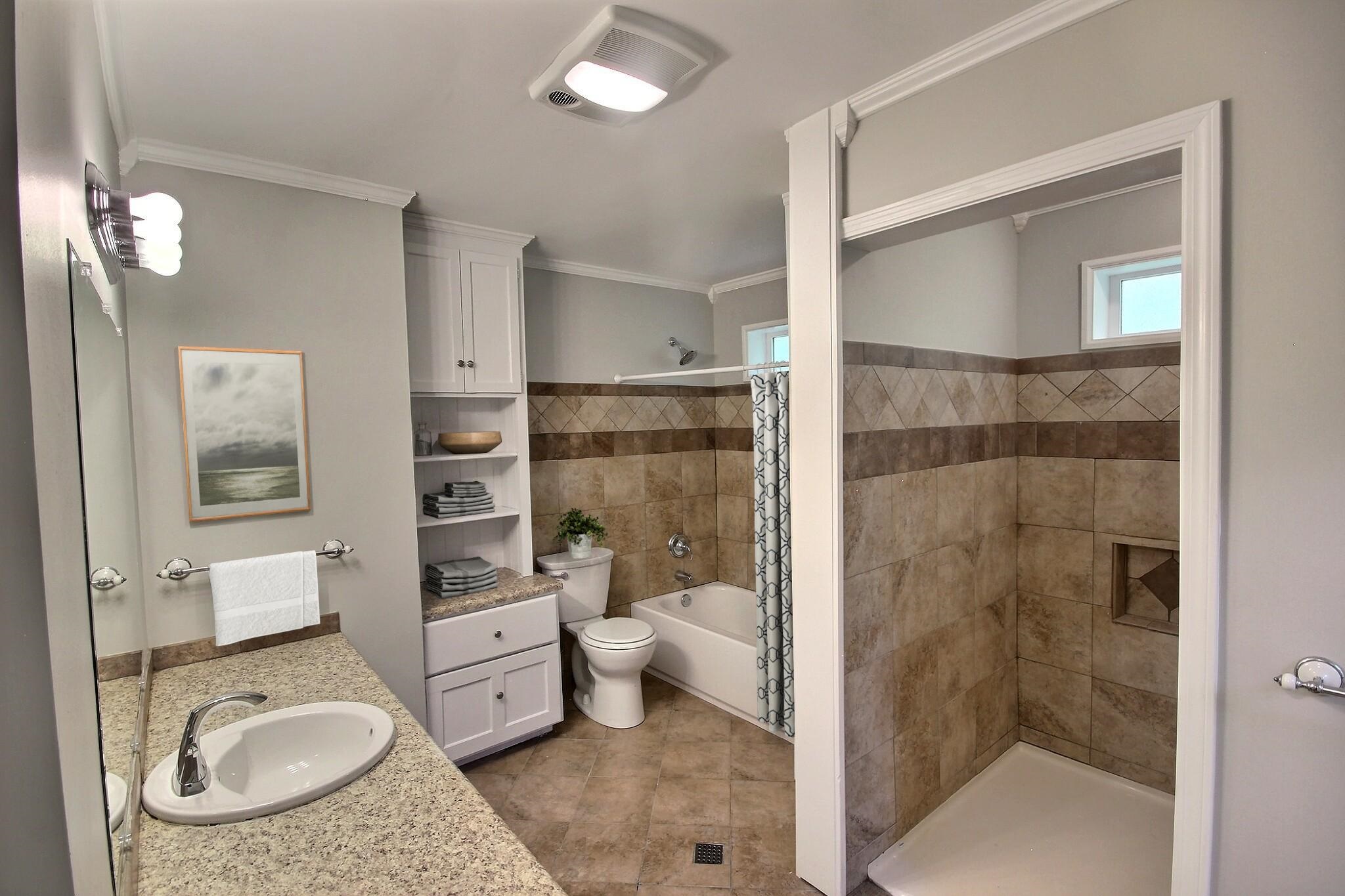 283 Andrew Way Road Collierville, TN 38017 - Photo 13 of 19 a bathroom with a granite countertop sink a toilet a mirror and shower