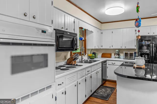 a kitchen with stainless steel appliances a sink stove and cabinets