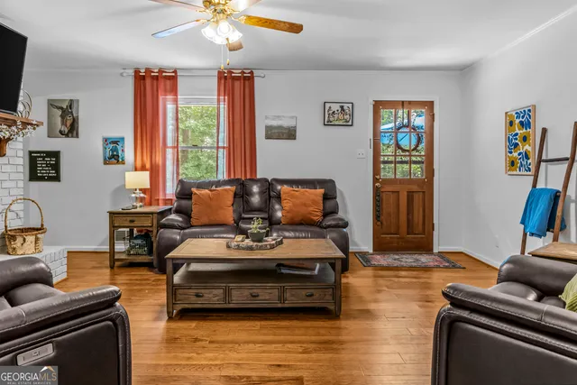 a living room with furniture a flat screen tv and a fireplace