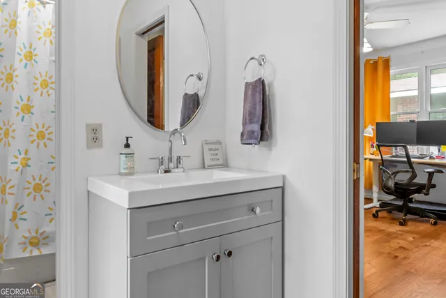 a bathroom with a sink a toilet and a mirror