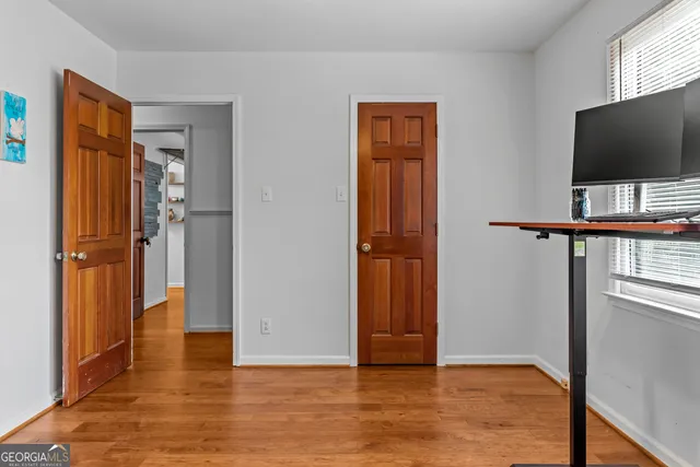 a bedroom with a bed a window and a chandelier