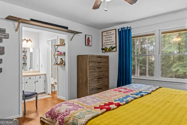 a bedroom with a bed dresser and a window