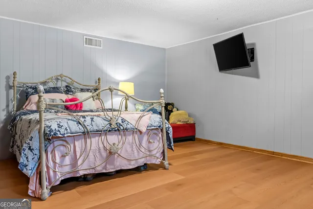 a bedroom with a bed and dresser