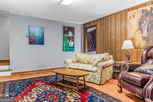 a bedroom with a bed furniture and a large window