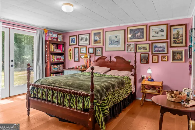 a bedroom with a bed and a large window