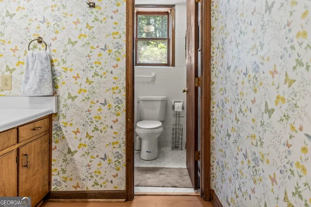a view of a balcony with chairs and wooden floor