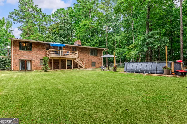 a backyard of a house with table and chairs