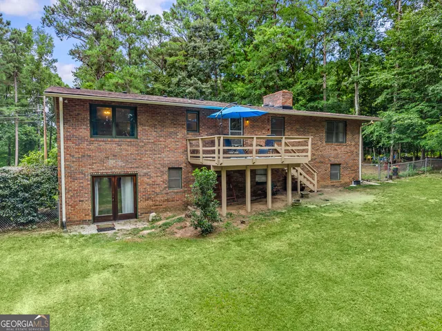 a view of a house with a yard covered in snow