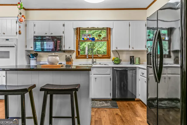 a kitchen with stainless steel appliances kitchen island granite countertop a sink and cabinets
