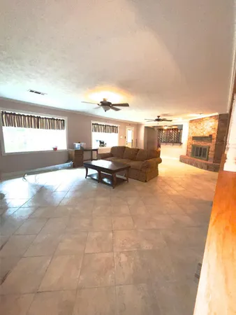 a living room with furniture and a kitchen view