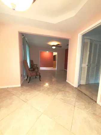 a view of a livingroom with furniture and staircase