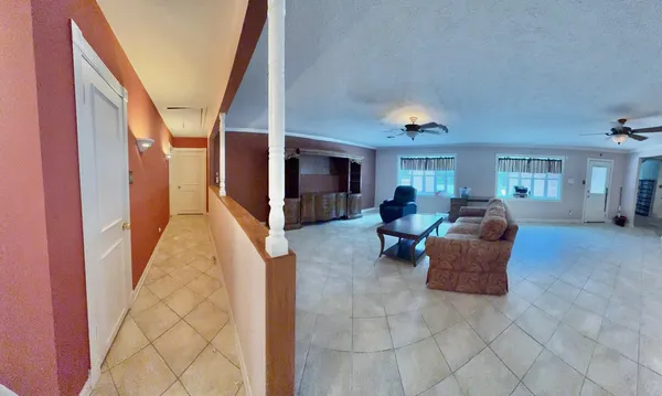 a living room with furniture a dining table and a chandelier