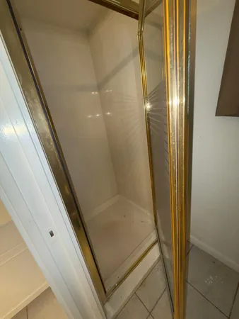 a bathroom with a glass door shower and vanity